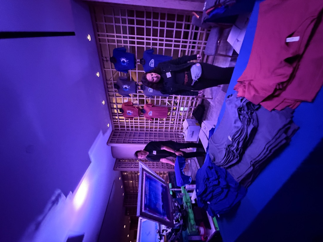 Live pressing station under purple evening lighting at a reception-style event