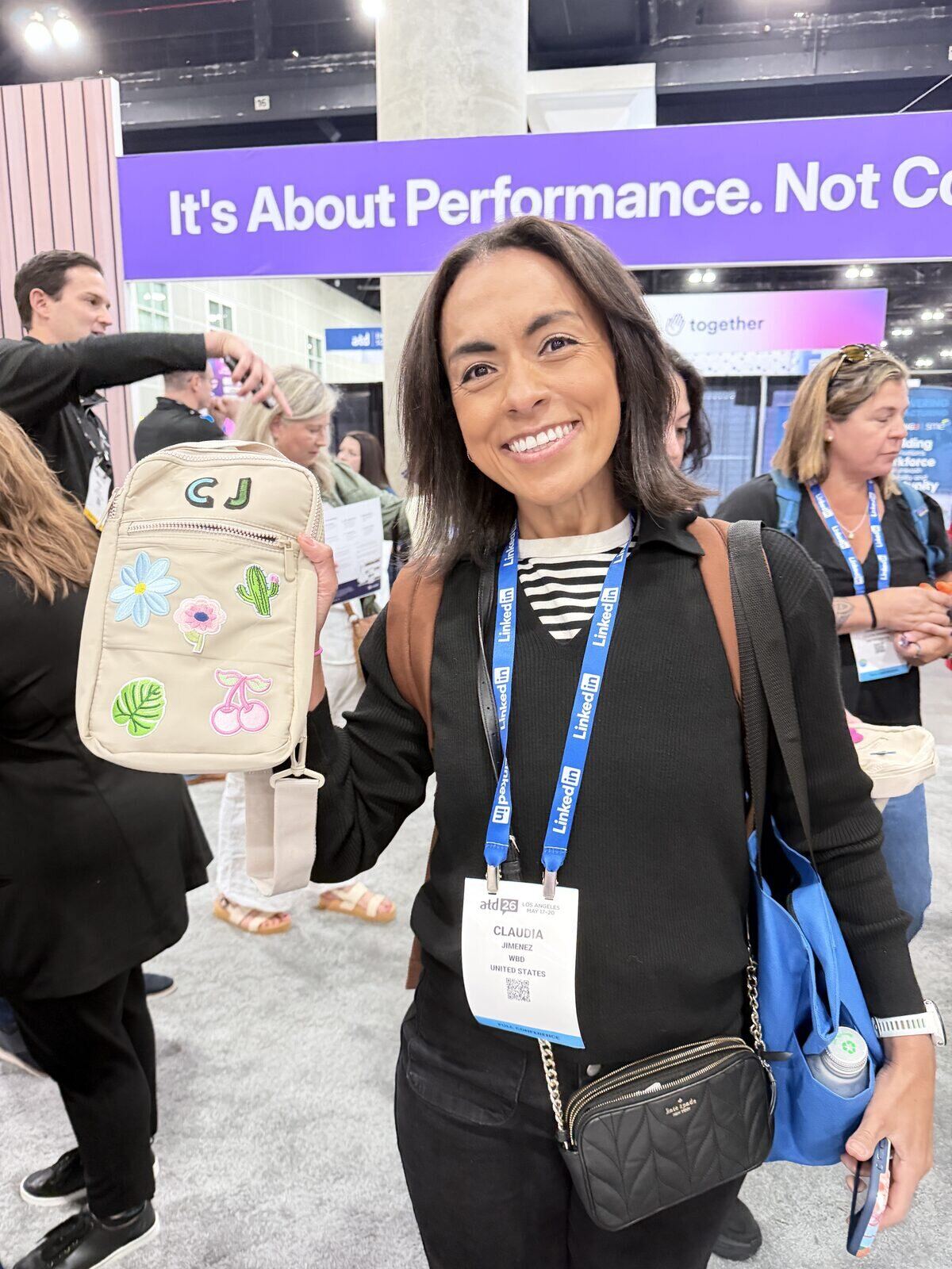 Guest showing off a bag decorated with pressed flower, cactus, and cherry patches